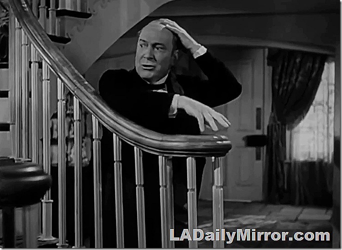 Bald man touching the top of his head. 