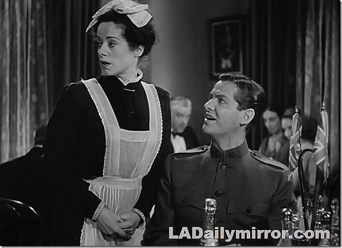 Woman in maid's outfit with man in military uniform. 