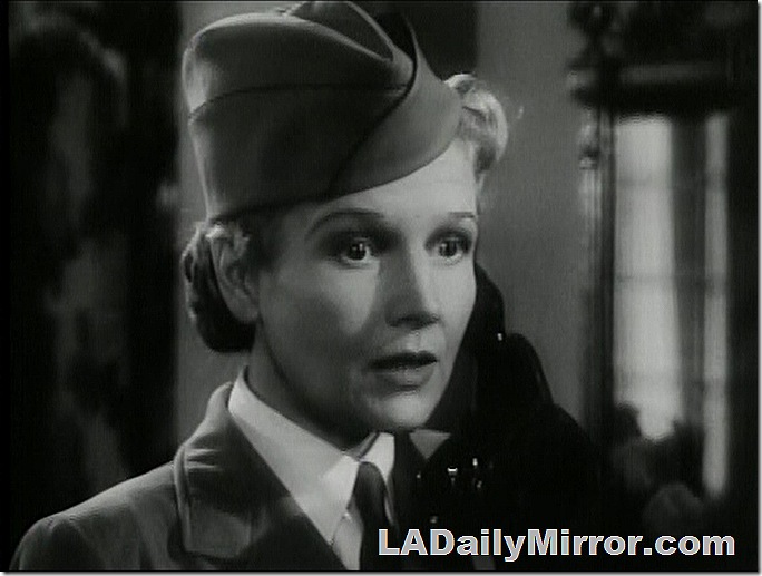 Woman in uniform, talking on the phone. 