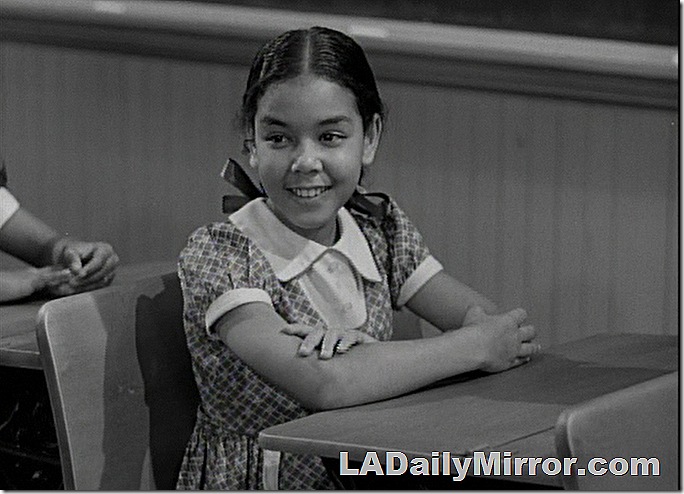 Girl sitting at desk. Her hair is in pigtails. Girl sitting at desk. Her hair is in pigtails.
