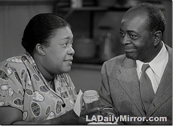 Woman with hair pulled back, man in suit and tie, smiling Woman with hair pulled back, man in suit and tie, smiling