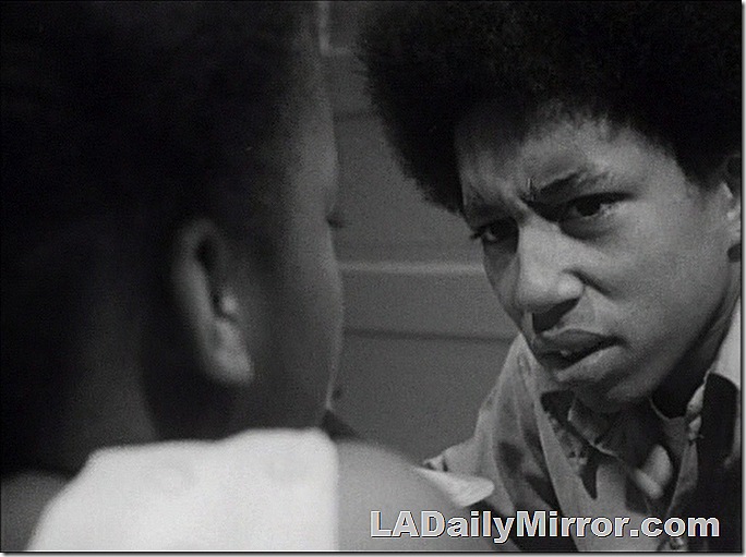 Youth with quizzical expression looking at girl.