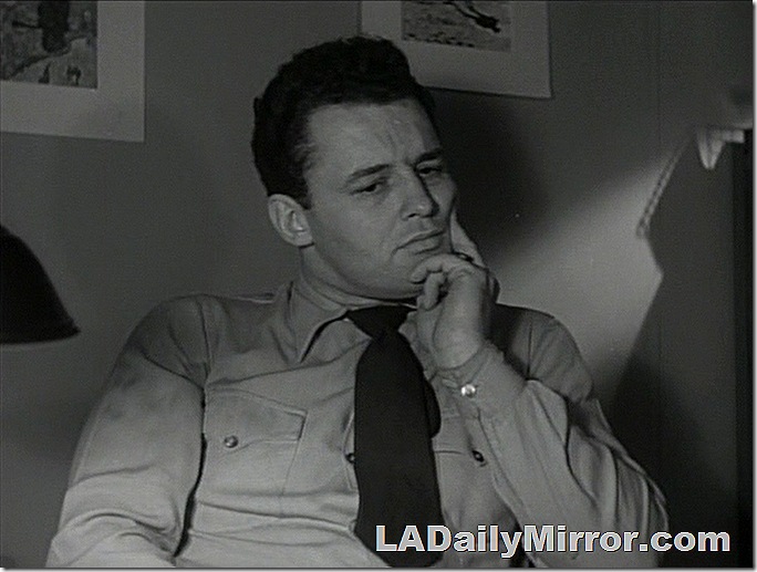 Man in shirt and tie with a contemplative expression. 