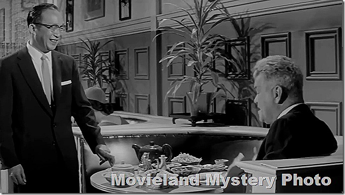 Mysterious man standing at restaurant booth, talking to mysterious customer. 