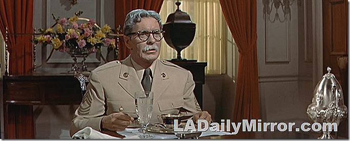 Man in uniform sitting at a table. 
