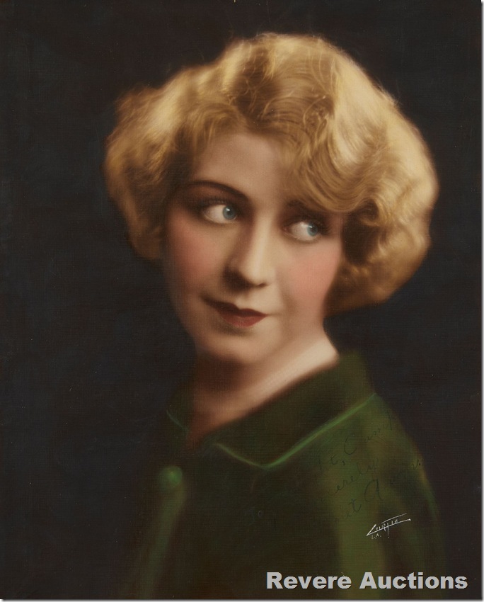 Woman with blond-reddish hair looking back over her left shoulder. 