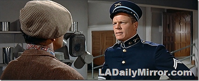 Man in high-collar uniform. With Back of the Head Guy. 