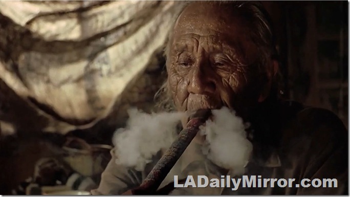 Man with weathered face smoking a pipe. 