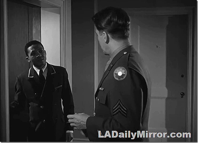 Man in uniform talking to man in military uniform. 