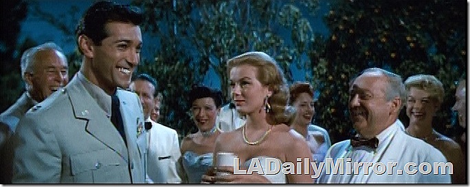 Army officer at party with woman and older man. 