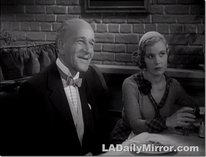 Man and woman sitting in a restaurant booth. 