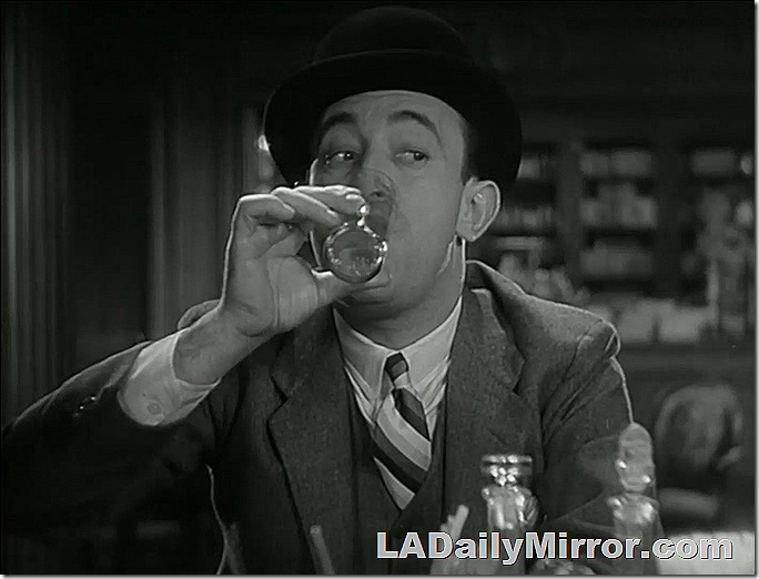 Mystery man at a bar having a drink. 