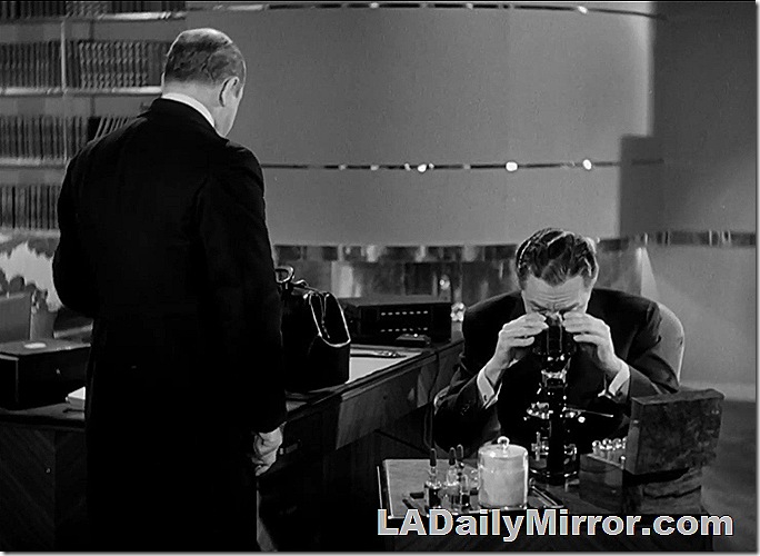 Man looking into microscope. Plus Back of the Head Guy. 