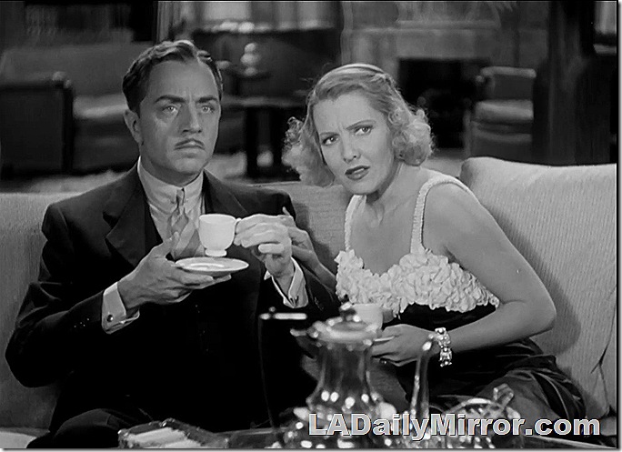 Man and woman sitting on couch, not approving of such goings-on. 