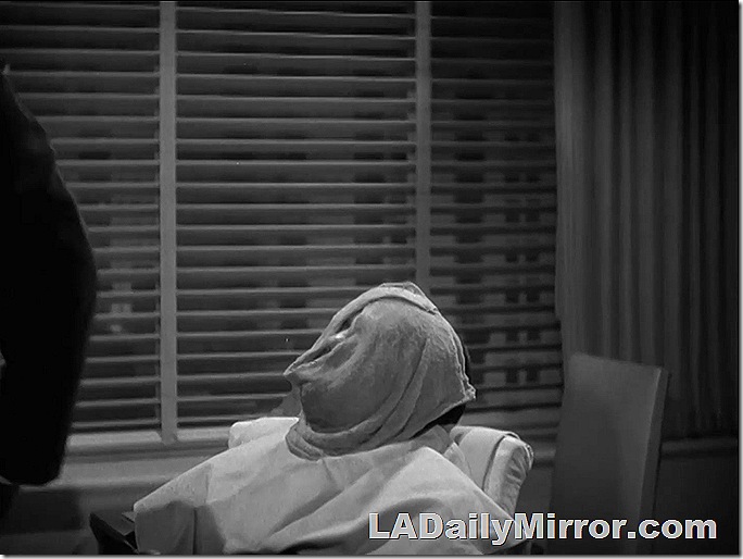 Man with face wrapped in hot towel. 