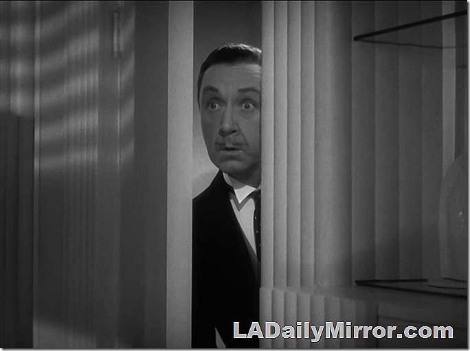 Man peeking through door with raised eyebrows!