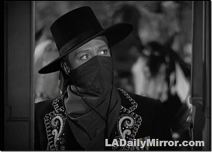 Man wearing mask in elaborate costume. 