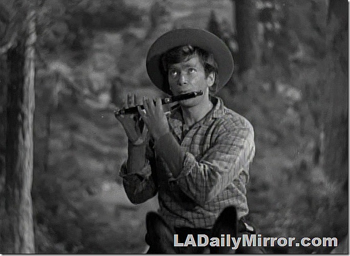 Man on horseback playing a flute. 