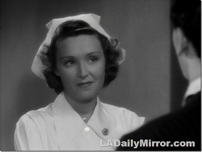 Woman in nurse's uniform and cap. 