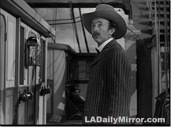 Man on a ship, wearing a cowboy hat