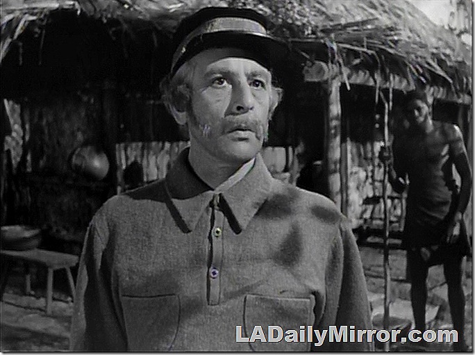 Man with a mustache wearing a cap. 