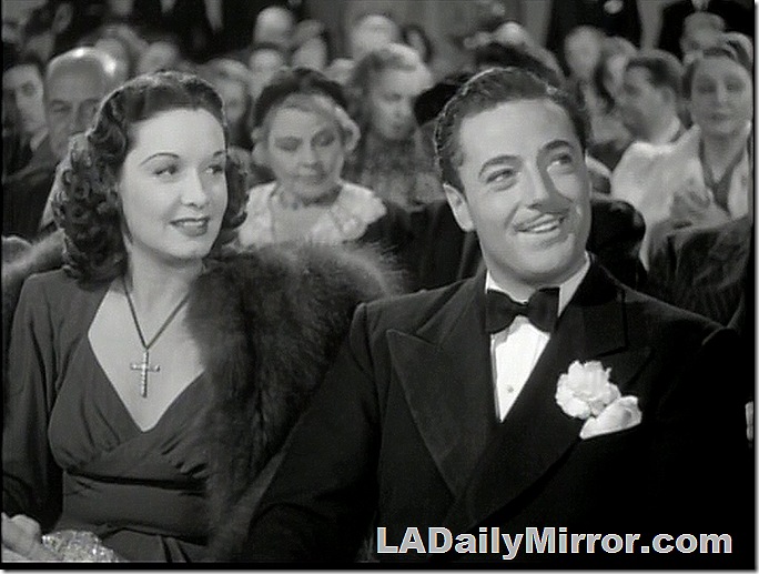 Man in tuxedo and woman with fur coat. 