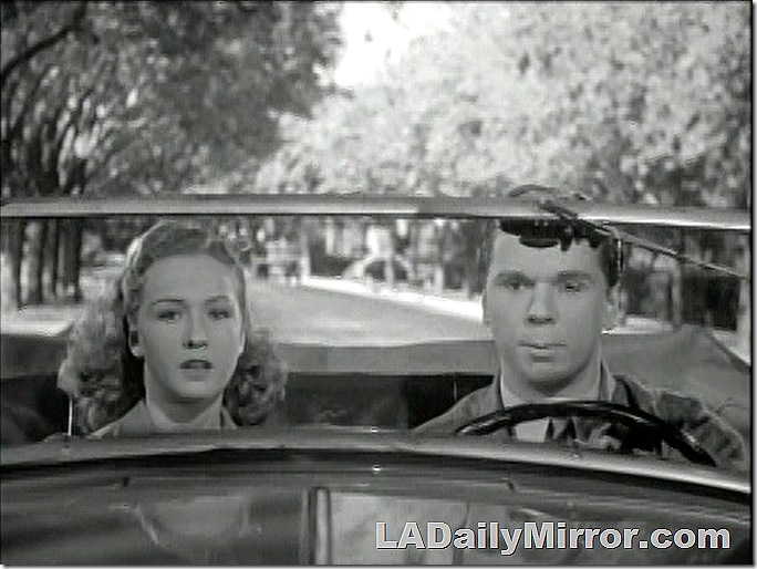 Young womand and young man in convertible. 
