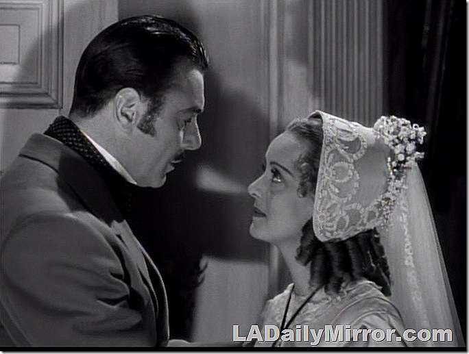 Man with sideburns in coat, looking at woman in elaborate dress and elegant bonnet. Man with sideburns in coat, looking at woman in elaborate dress and elegant bonnet.