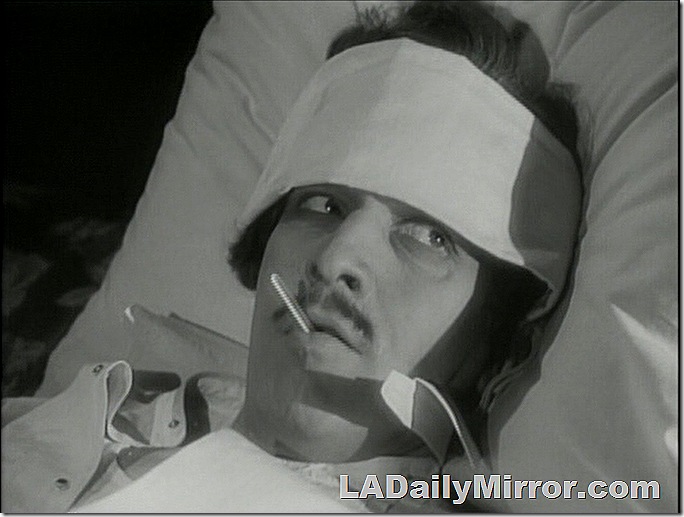 Man with bandaged head and a thermometer in his mouth Man with bandaged head and a thermometer in his mouth