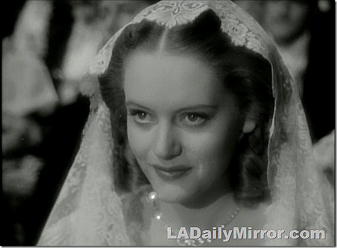 Woman with scarf on her head, wearing elegant gown. Woman with scarf on her head, wearing elegant gown.