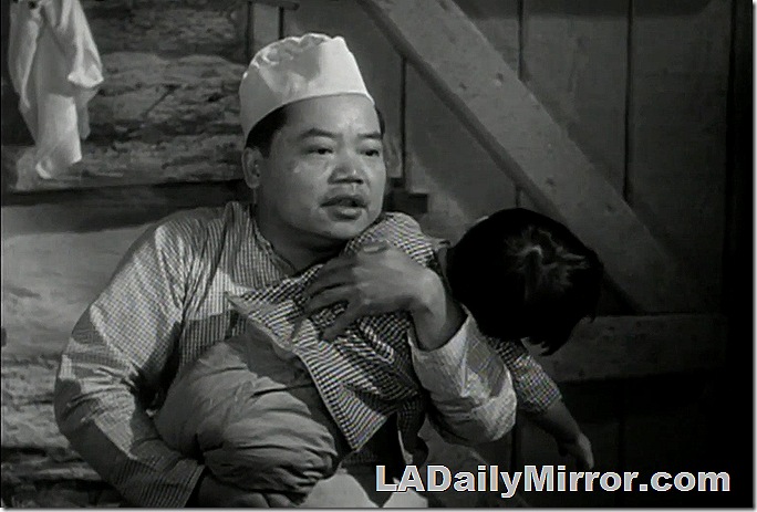 Asian man holds boy. 