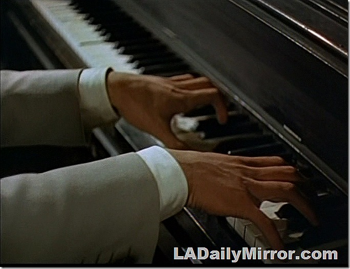 Man's hands playing the piano. 