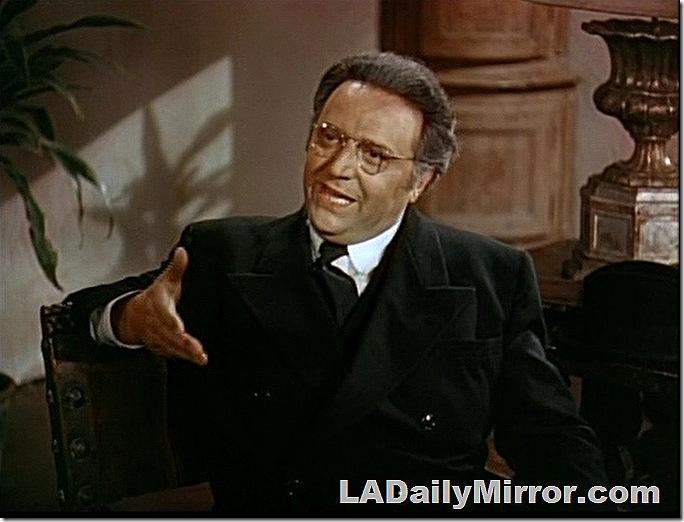 Man in dark suit and glasses. 