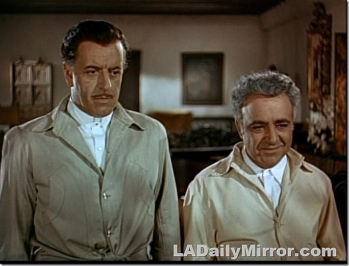 Two men in light colored jackets with shirts buttoned at the neck. 