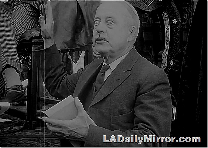 Distinguished man in coat, vest and tie, with a small mustache. 