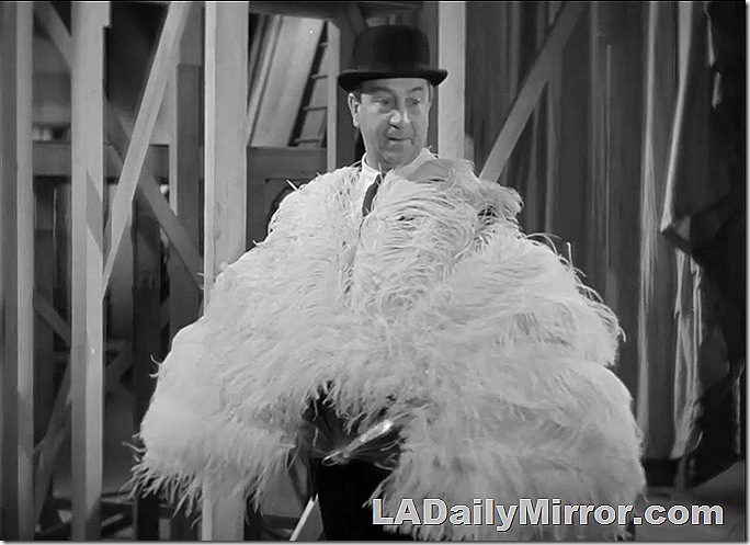 Man in bowler hat wearing ostrich feathers. Man in bowler hat wearing ostrich feathers.