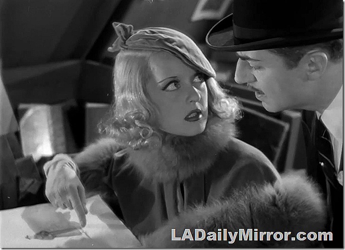 Woman with a fur stole and a beret pointing to a book as a man in a bowler hat looks. Woman with a fur stole and a beret pointing to a book as a man in a bowler hat looks.