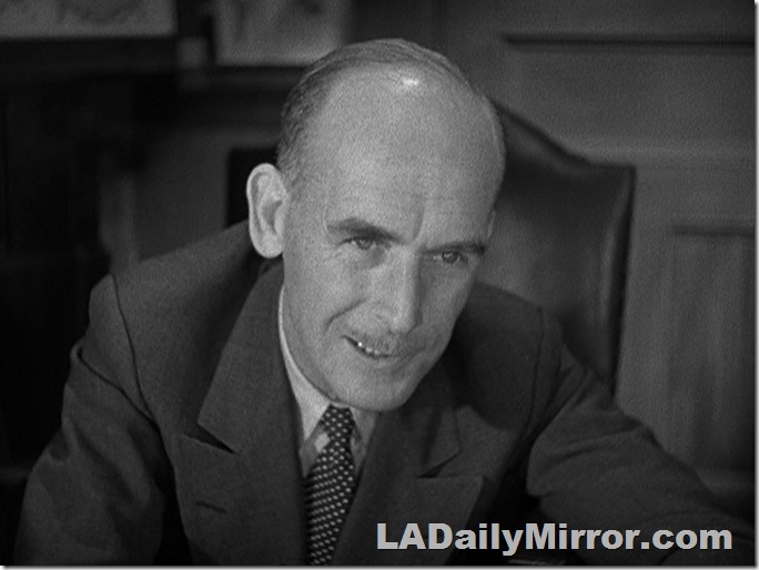 Balding man in double-breasted suit. 