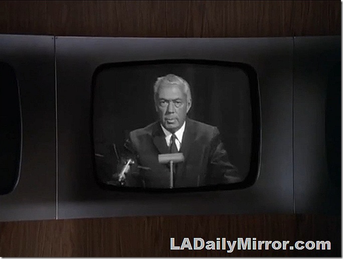 Man in coat and tie on TV screen Man in coat and tie on TV screen