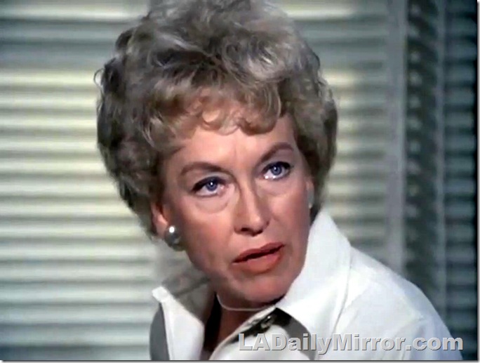 Woman with short hair, open collar, earrings and a necklace. Woman with short hair, open collar, earrings and a necklace.