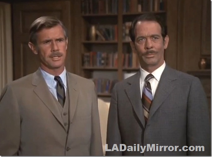 Two men in suits, both have mustaches. Two men in suits, both have mustaches.