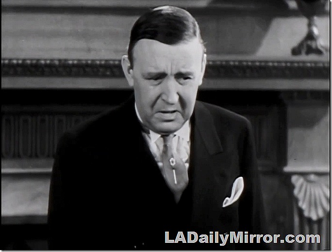 Man in suit and shirt with wing collar. 