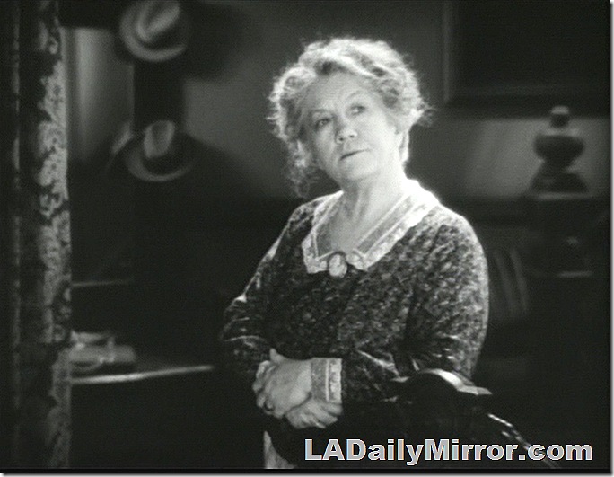 Woman with mussy hair, cameo pinned to her neckline. Woman with mussy hair, cameo pinned to her neckline.