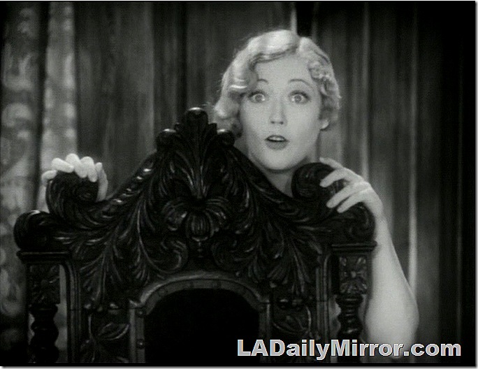 Blonde woman with short, curly hair, hiding behind a chair. Blonde woman with short, curly hair, hiding behind a chair.