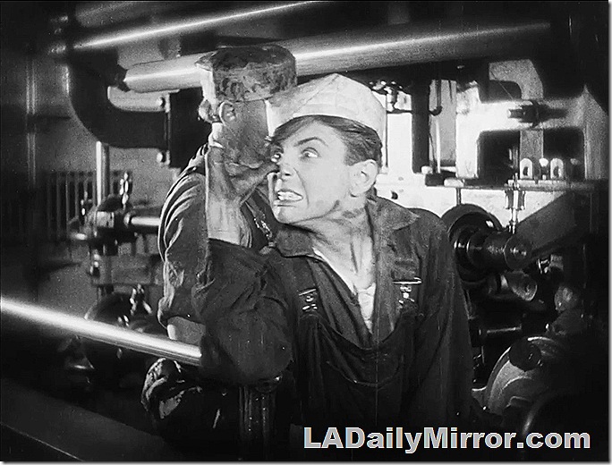 A young man makes an unflattering gesture and grimaces. A young man makes an unflattering gesture and grimaces.