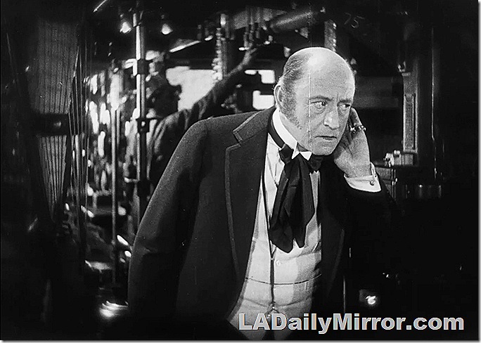 Man in coat and wing collar with string tie, on telephone. Man in coat and wing collar with string tie, on telephone.