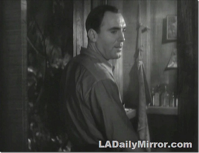 Man standing in doorway of cabin