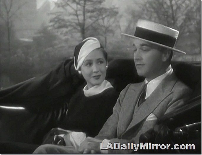 Man and woman riding in Central Park carriage. 