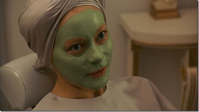 Woman with face covered in green substance. Woman with face covered in green substance.