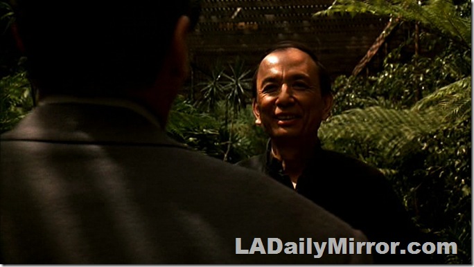 Man visible over mystery Back of the Head Guy's shoulder. 